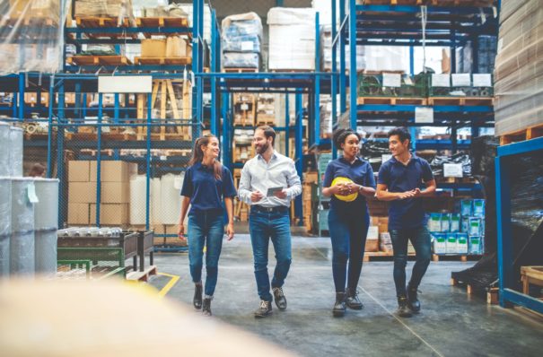 Workers walking through a warehouse.