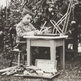 Vintage photo of a child working at a desk.