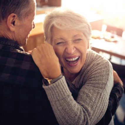 Close up of a senior couple dancing.