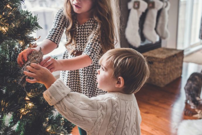 two family members decorating a christmas tree